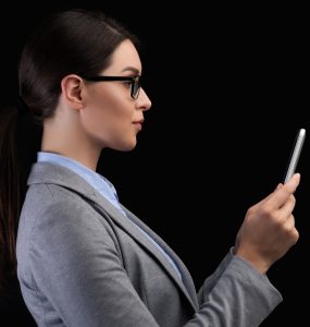 Businesswoman Using Smartphone Face Recognition System On Black Background